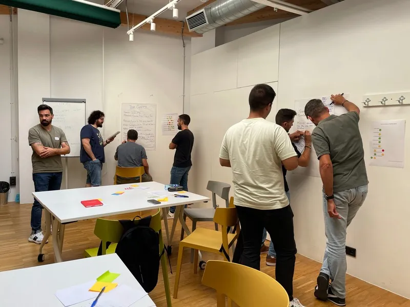 Bootcamp participants working in groups at whiteboards